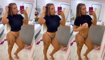 Andressa Urach na frente do espelho exibindo as tetas